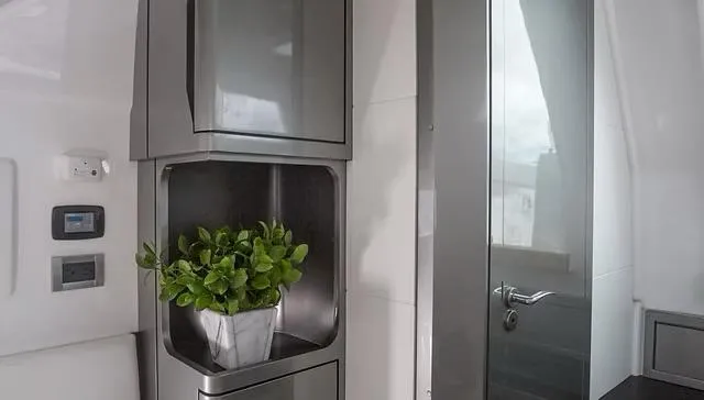  Yacht Photos Pics Modern interior of Schaefer V33 yacht, featuring sleek cabinets and a potted plant, 2025 model.