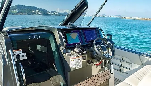  Yacht Photos Pics Cockpit of 2025 Schaefer V33 boat with modern navigation systems, steering wheel, and ocean view.