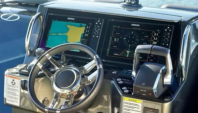  Yacht Photos Pics Steering console of 2025 Schaefer V33 boat with navigation screens and controls.