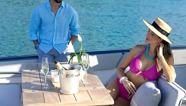  Yacht Photos Pics Couple relaxing on Schaefer V33 yacht, enjoying drinks, 2025 model.