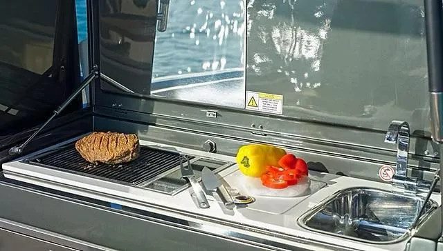 Yacht Photos Pics Outdoor kitchen on Schaefer V33 yacht with grill, vegetables, and sink, 2025 model.