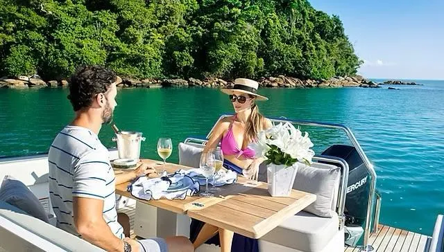 Yacht Photos Pics Couple enjoying a meal on a 2025 Schaefer V33 yacht, surrounded by scenic ocean views.
