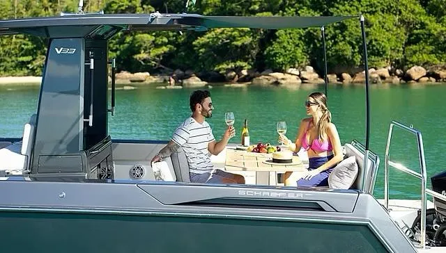  Yacht Photos Pics Couple enjoying drinks on a 2025 Schaefer V33 yacht in a scenic bay.