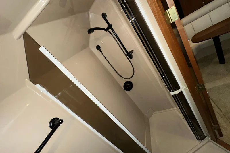  Yacht Photos Pics 1999 Cruisers Yachts 3870 Esprit bathroom with shower and wooden door.