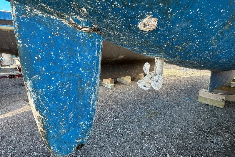 Gratitude Yacht Photos Pics Barnacle-covered hull and propeller of a 2015 Leopard 48 catamaran on dry dock.