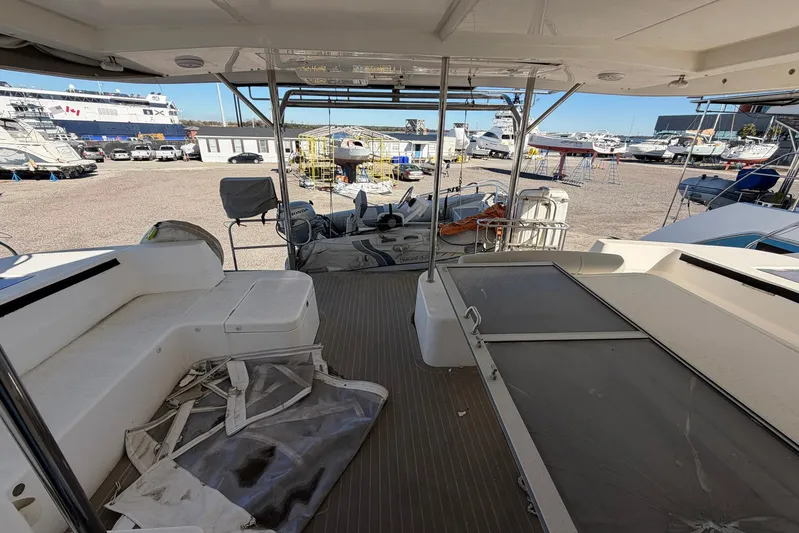 Gratitude Yacht Photos Pics 2015 Leopard 48 yacht interior with seating, docked in a marina with other boats.