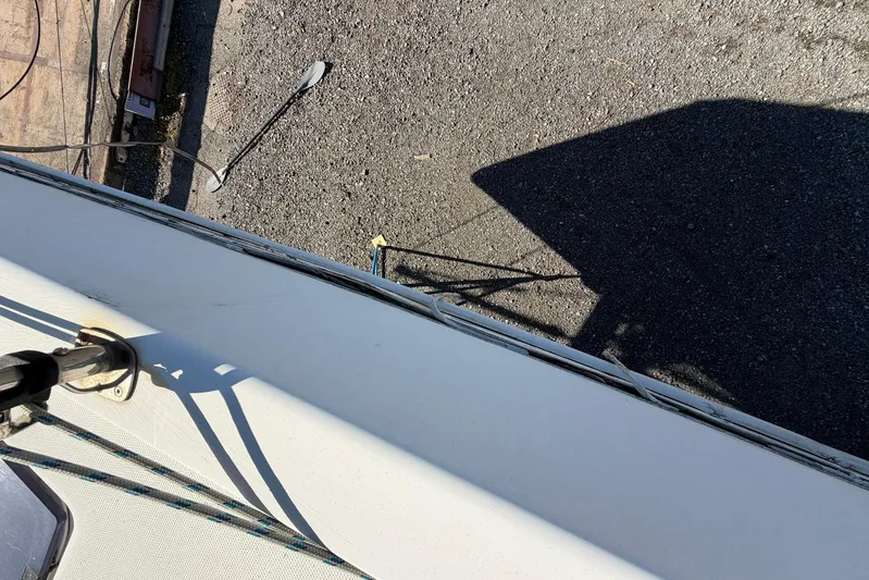 Gratitude Yacht Photos Pics Top view of a 2015 Leopard 48 yacht deck with visible railing and shadow.