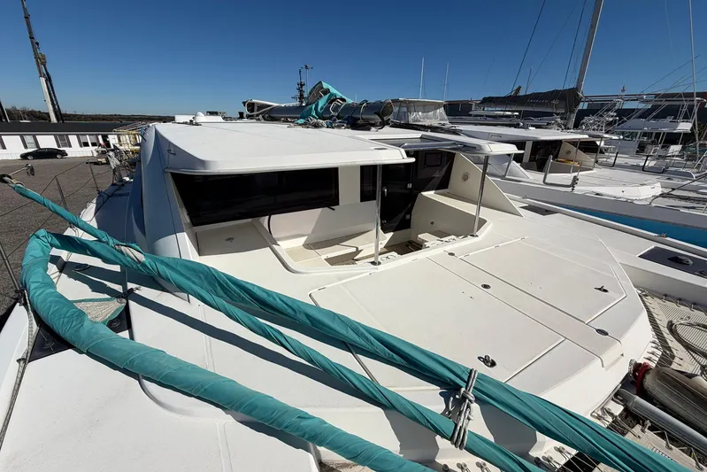 Gratitude Yacht Photos Pics 2015 Leopard 48 catamaran docked, showcasing spacious deck and sleek design.