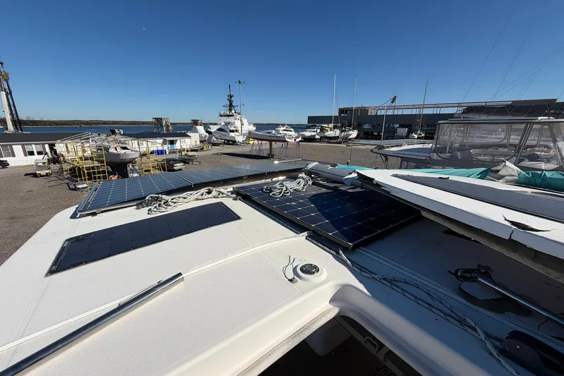Gratitude Yacht Photos Pics 2015 Leopard 48 yacht with solar panels, docked at a marina under clear blue skies.