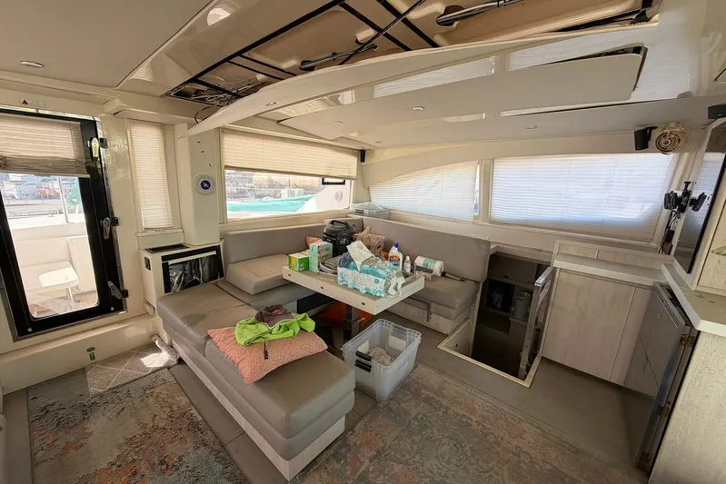 Gratitude Yacht Photos Pics Interior of a 2015 Leopard 48 yacht with modern seating and table setup.