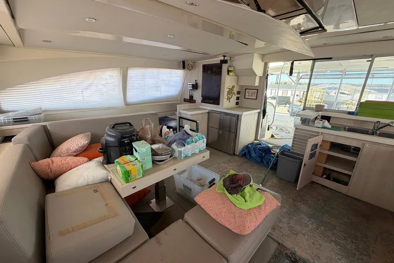 Gratitude Yacht Photos Pics Interior of 2015 Leopard 48 yacht with kitchen and seating area, featuring various items.