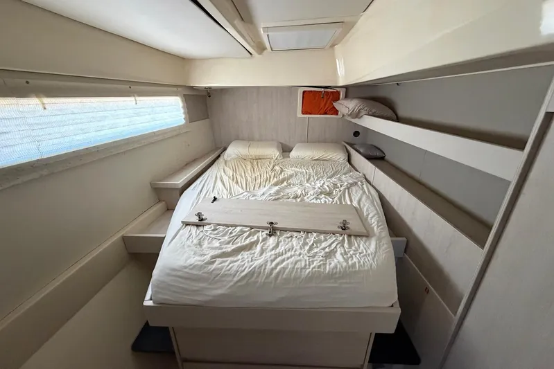 Gratitude Yacht Photos Pics Cozy bedroom interior of 2015 Leopard 48 yacht with double bed and modern design.