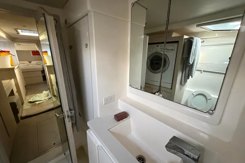 Gratitude Yacht Photos Pics Bathroom interior of 2015 Leopard 48 yacht with sink, mirror, and washer.