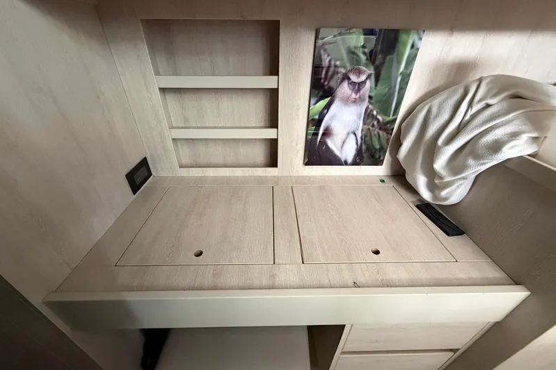 Gratitude Yacht Photos Pics Wooden interior of 2015 Leopard 48 yacht with monkey photo and towel.