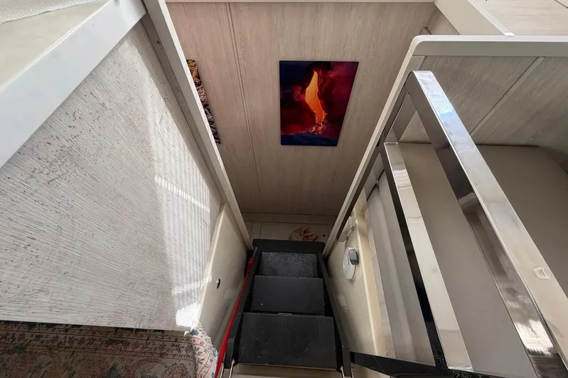 Gratitude Yacht Photos Pics Staircase in 2015 Leopard 48 yacht with modern artwork on wall.