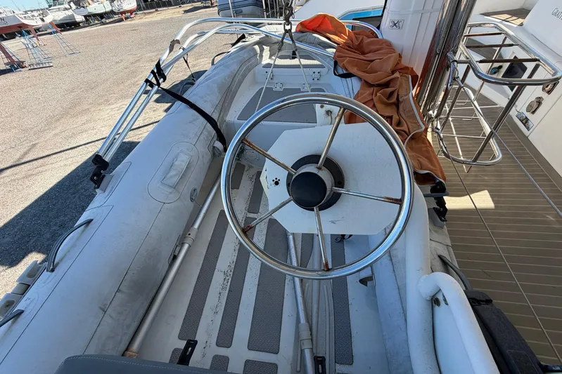 Gratitude Yacht Photos Pics Steering wheel of a 2015 Leopard 48 yacht, docked with equipment visible.