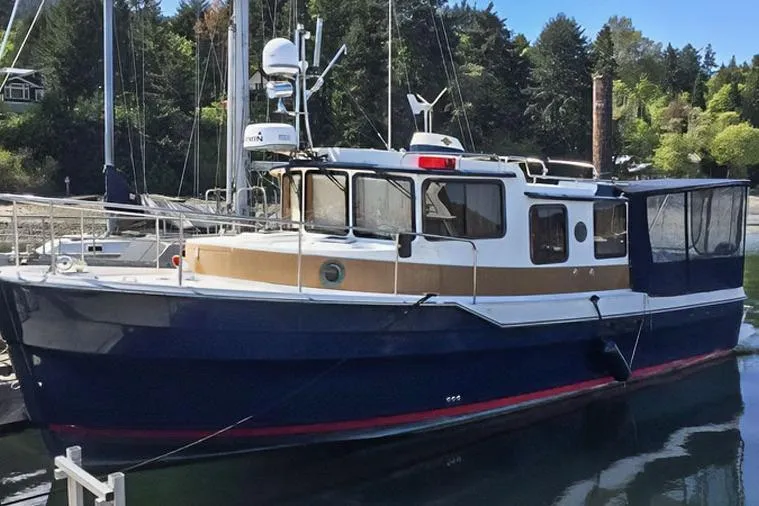 Mi Callao Yacht Photos Pics 2015 Ranger Tugs R-31 S boat docked in a serene marina setting.