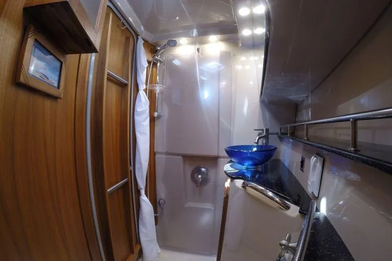 Mi Callao Yacht Photos Pics Luxurious bathroom in 2015 Ranger Tugs R-31S with modern fixtures and blue glass sink.
