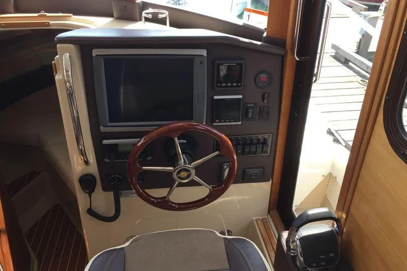 Mi Callao Yacht Photos Pics 2015 Ranger Tugs R-31S helm with wooden steering wheel and navigation controls.