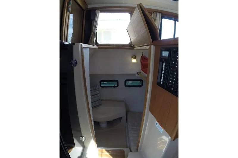 Mi Callao Yacht Photos Pics 2015 Ranger Tugs R-31S interior cabin with seating, windows, and control panel.
