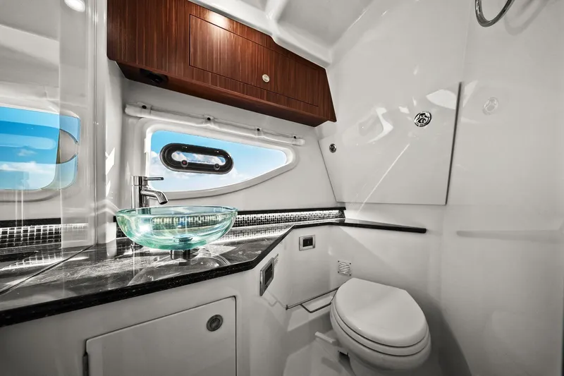  Yacht Photos Pics Luxurious bathroom in 2023 Sea Ray Sundancer 370 Outboard with modern fixtures and ocean view.
