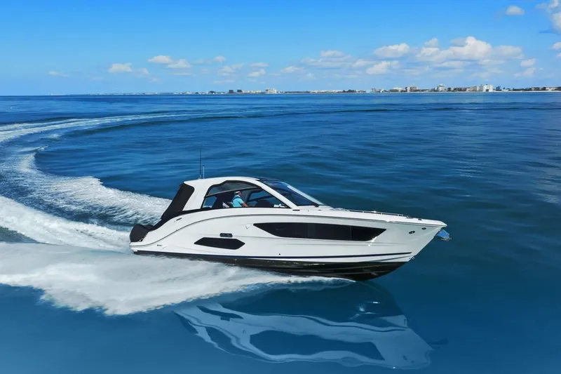  Yacht Photos Pics 2023 Sea Ray Sundancer 370 Outboard cruising on open water under a clear blue sky.