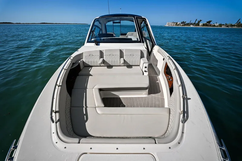  Yacht Photos Pics 2023 Sea Ray Sundancer 370 Outboard boat with spacious seating on calm water.