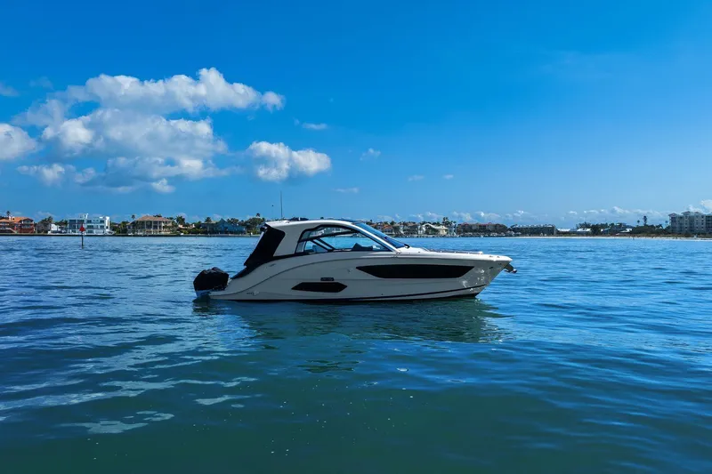  Yacht Photos Pics 2023 Sea Ray Sundancer 370 Outboard cruising on a sunny day with coastal backdrop.