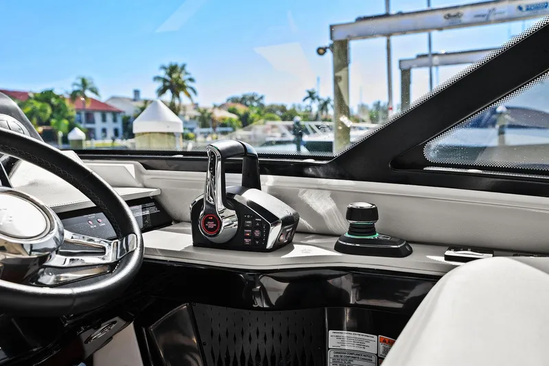  Yacht Photos Pics Interior view of 2023 Sea Ray Sundancer 370 Outboard helm with controls and steering wheel.