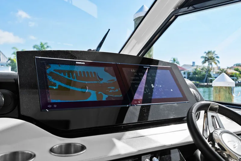  Yacht Photos Pics 2023 Sea Ray Sundancer 370 Outboard dashboard with Simrad display, steering wheel, and water view.