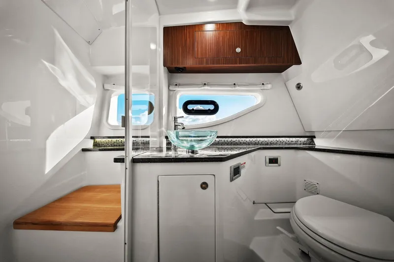  Yacht Photos Pics Luxurious bathroom interior of 2023 Sea Ray Sundancer 370 Outboard yacht with modern fixtures.