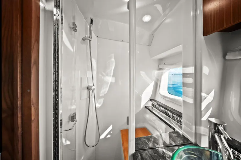  Yacht Photos Pics 2023 Sea Ray Sundancer 370 Outboard bathroom with modern shower and ocean view window.