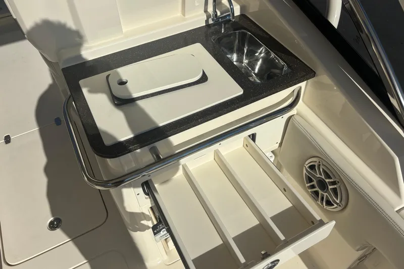  Yacht Photos Pics 2026 Scout 255 Dorado boat interior with sink, cutting board, and storage drawers.