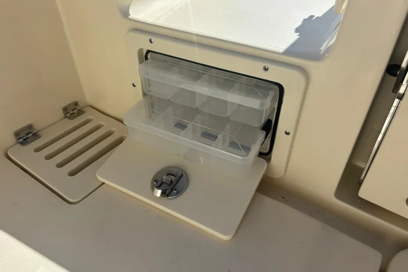  Yacht Photos Pics Storage compartment on 2026 Scout 255 Dorado boat with clear plastic organizer.