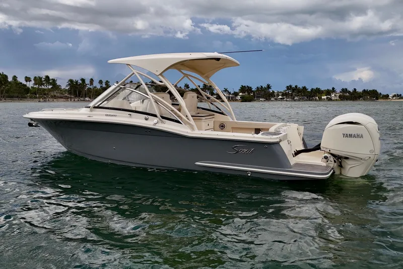  Yacht Photos Pics 2026 Scout 255 Dorado boat on water with Yamaha engine, under cloudy sky.