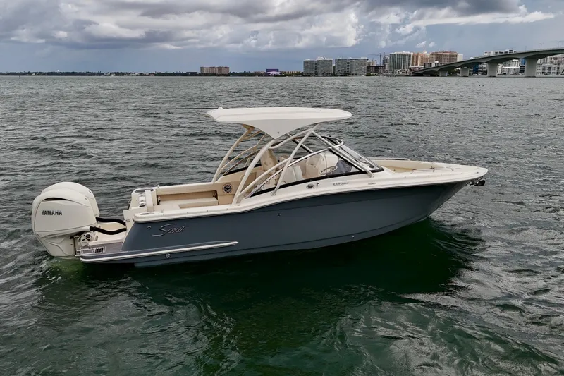  Yacht Photos Pics 2026 Scout 255 Dorado boat on water with Yamaha engine, cityscape background.