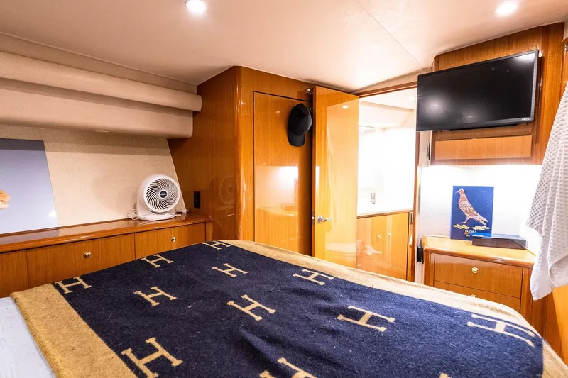 Geaux Time Yacht Photos Pics Luxurious cabin interior of 2002 Viking 52 Convertible yacht with elegant wood finishes.