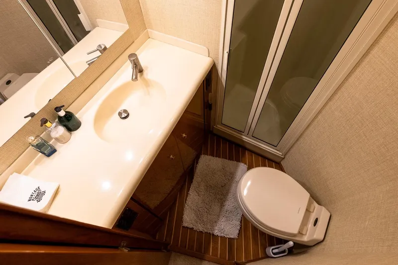Geaux Time Yacht Photos Pics Bathroom interior of 2002 Viking 52 Convertible yacht with sink and toilet.