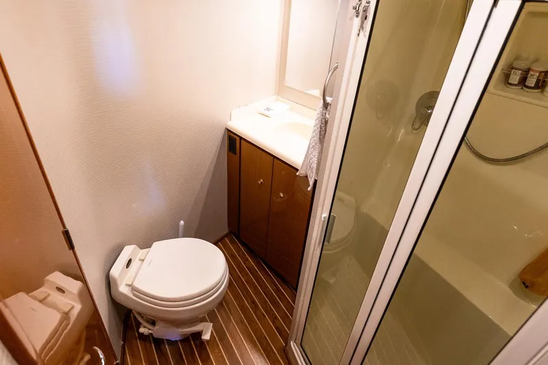 Geaux Time Yacht Photos Pics Bathroom interior of 2002 Viking 52 Convertible yacht with shower and toilet.