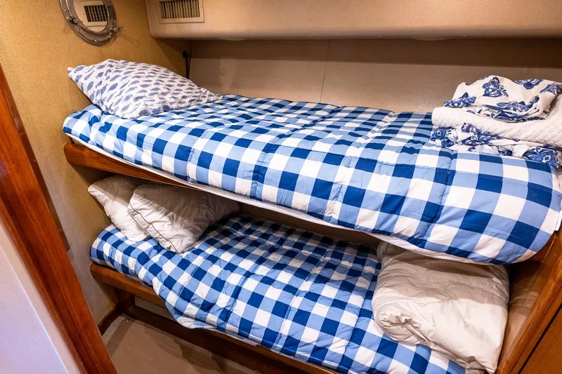 Geaux Time Yacht Photos Pics Bunk beds with blue checkered bedding in a 2002 Viking 52 Convertible yacht cabin.