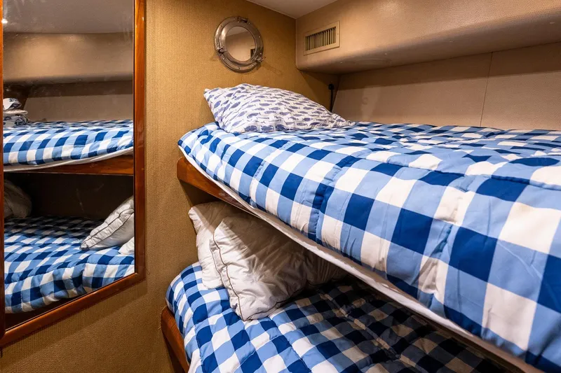 Geaux Time Yacht Photos Pics Bunk beds with blue checkered bedding in 2002 Viking 52 Convertible yacht cabin.