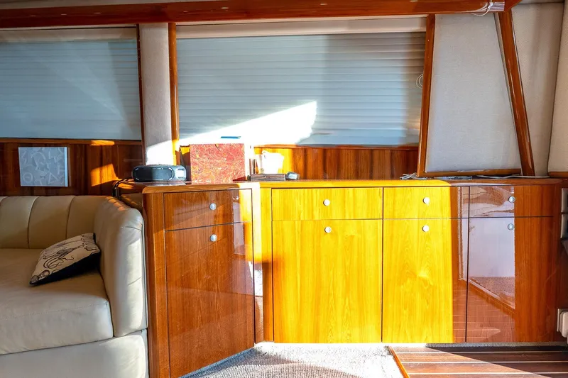Geaux Time Yacht Photos Pics Luxurious interior of a 2002 Viking 52 Convertible yacht with polished wood cabinetry.