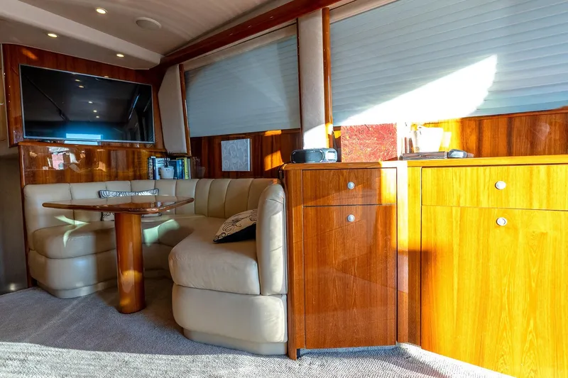 Geaux Time Yacht Photos Pics Luxurious interior of a 2002 Viking 52 Convertible yacht with leather seating and wood cabinetry.