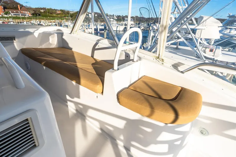 Geaux Time Yacht Photos Pics Interior view of 2002 Viking 52 Convertible yacht with tan seating and marina background.