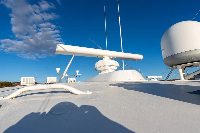 Geaux Time Yacht Photos Pics Radar equipment on a 2002 Viking 52 Convertible yacht under a clear blue sky.