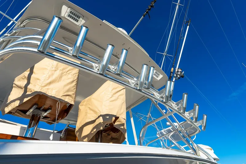 Geaux Time Yacht Photos Pics 2002 Viking 52 Convertible yacht with fishing rod holders against a clear blue sky.