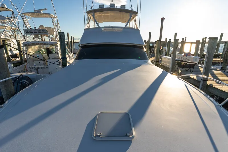 Geaux Time Yacht Photos Pics 2002 Viking 52 Convertible yacht docked at marina during sunset.