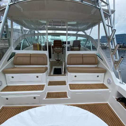 Wendy Ann Yacht Photos Pics 2021 Albemarle 41 Express yacht interior with tan seating and wooden flooring.