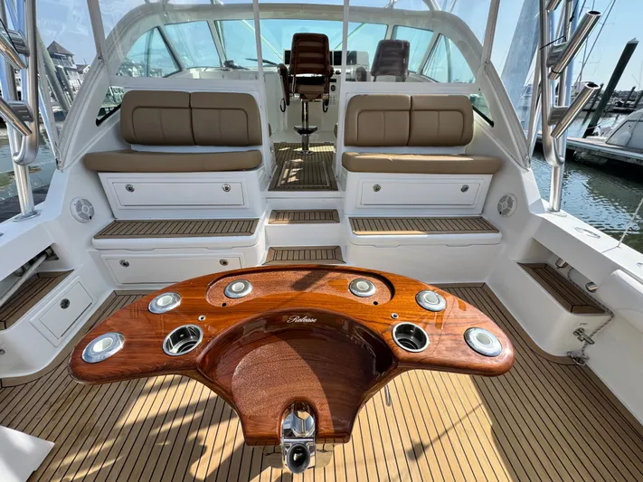Wendy Ann Yacht Photos Pics 2021 Albemarle 41 Express boat interior with teak flooring and cushioned seating.