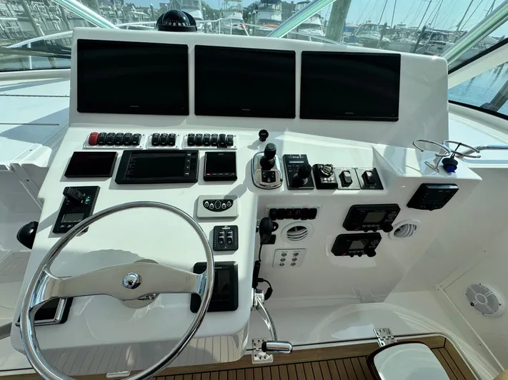 Wendy Ann Yacht Photos Pics Control panel of 2021 Albemarle 41 Express boat with steering wheel and navigation screens.
